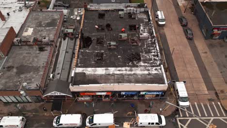 An-aerial-view-of-the-aftermath-of-a-multi-alarm-fire-of-small-businesses-on-a-cloudy-day