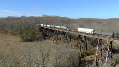 Aerial-Shot-Pushing-in-Towards-a-Mixed-Freight-Train-Crossing-The-Pope-Lick-Trestle-in-Kentucky-during-Winter