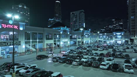 Shopping-Mall-with-parking-area-and-skyline-of-Atlanta-City-at-night