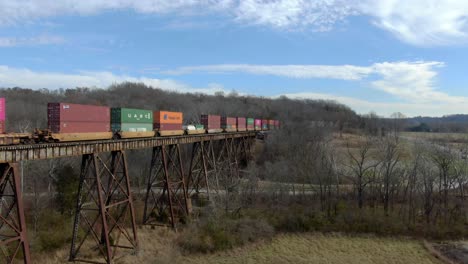 Aerial-Shot-of-an-Intermodal-Freight-Train-Crossing-the-Pope-Lick-Trestle-in-Louisville-Kentucky-in-the-Winter