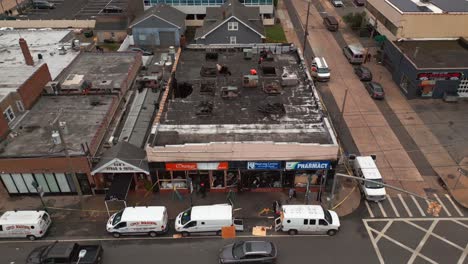 An-aerial-view-of-the-aftermath-of-a-multi-alarm-fire-of-small-businesses-on-a-cloudy-day