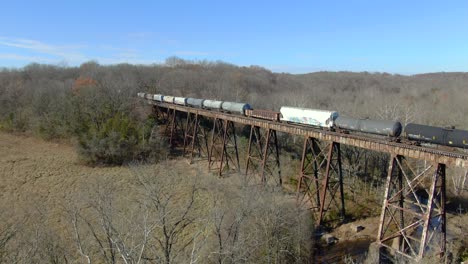 Aerial-Shot-Pushing-in-Towards-a-Mixed-Freight-Train-Crossing-The-Pope-Lick-Trestle-during-Winter