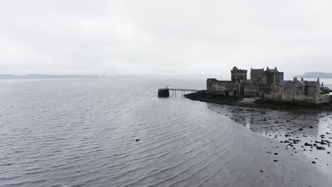 Drone-shot-of-Blackness-Castle-surrounded-by-the-North-Sea