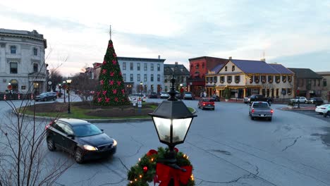 Rising-drone-shot-of-decorated-Christmas-wreath-on-lantern-in-small-American-city