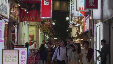Japanese-People-walking-through-a-narrow-alley-at-night