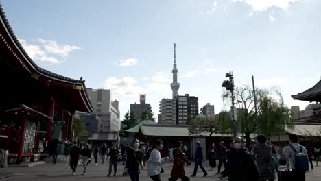 Belebtes-öffentliches-Treiben-Auf-Dem-Gelände-Des-Senso-ji-Tempels-Mit-Dem-Skytree-Turm-Im-Hintergrund
