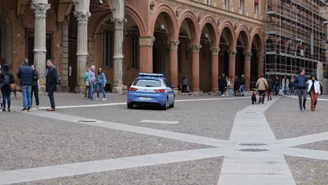 Blue-Seat-Leon-car-of-Italian-police-called-Polizia-in-the-streets-of-Bologna,-Italy-in-slow-motion