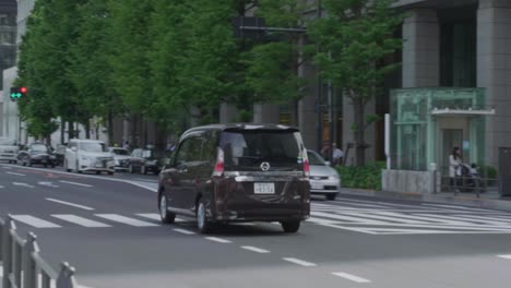 a-car-driving-along-a-road-in-Tokyo,-Japan