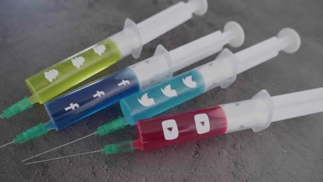 several-syringes-filled-with-colorful-liquid-symbolizing-social-media-addiction-and-the-facebook-Symbol-being-picked-up