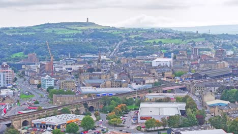 A-panoramic-aerial-shot-of-Huddersfield:-railway,-bridge,-city-roads,-buildings,-warehouses,-offices,-and-residential-buildings-inhabit-the-city