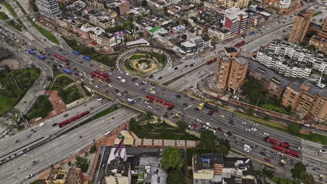Bogota-Colombia-Aerial-v44-birds-eye-view,-fly-around-intersection-between-avenue-NQS-and-El-Dorado-highway-capturing-busy-traffics-and-downtown-cityscape---Shot-with-Mavic-3-Cine---November-2022