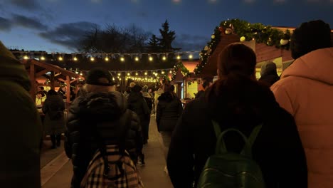 People-walking-around-at-Sofia-Christmas-Fest-2023,-at-night