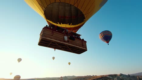 Hot-Air-Balloons-Against-Blue-Sky-In-Cappadocia,-Turkey---Aerial-FPV