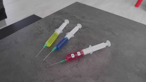 several-syringes-filled-with-colorful-liquid-symbolizing-social-media-addiction-with-the-twitter-symbol-being-picked-up