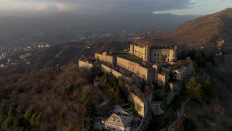 Forte-Sperone-on-a-hill-during-sunset,-overlooking-Genoa,-aerial-view