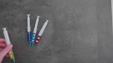 several-syringes-filled-with-colorful-liquid-symbolizing-social-media-addiction-and-the-Snapchat-Symbol-being-picked-up