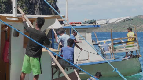 Several-Filipinos-preparing-their-wooden-boats-to-do-some-island-hopping-with-tourists-in-the-philippines