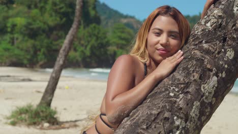 A-bikini-clad-young-woman-embraces-a-tropical-Caribbean-beach-with-soft-white-sand