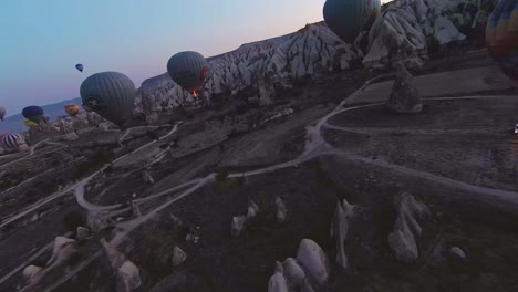 Colorful-Hot-Air-Balloons-Over-The-Valley-At-Cappadocia,-Turkey---Aerial-FPV