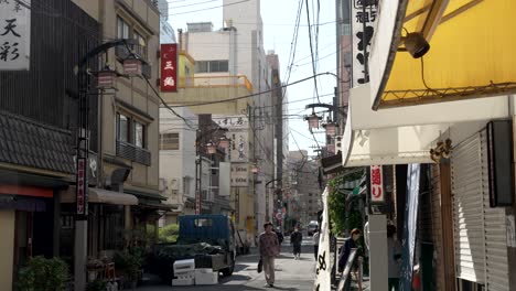 Narrow-Side-Street-In-Tokyo,-a-captivating-morning-scene-unfolds-along-a-charming-side-street