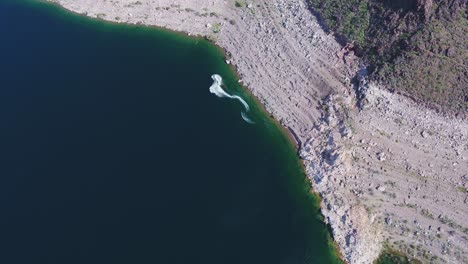 A-high-flying-drone-shot-over-Lake-Mead,-a-massive-reservoir-formed-by-the-Hoover-Dam-on-the-Colorado-River,-that-lies-on-the-border-of-Arizona-and-Nevada,-just-east-of-Las-Vegas