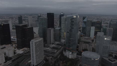 Aerial-drone-shot-of-the-modern-La-Defense-business-district-in-Paris,-France-in-the-early-morning-on-a-cloudy-day
