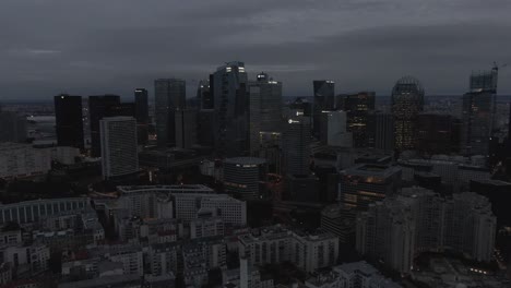 Aerial-drone-shot-of-the-modern-La-Defense-business-district-in-Paris,-France-in-the-early-morning-on-a-cloudy-day