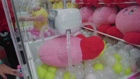 People-playing-a-Claw-Machine-at-an-Arcade-in-Tokyo,-Japan
