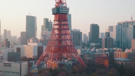 Aerial-drone-shot-of-the-famous-Tokyo-Tower-and-the-beautiful-skyline-of-Tokyo,-Japan-during-sunset