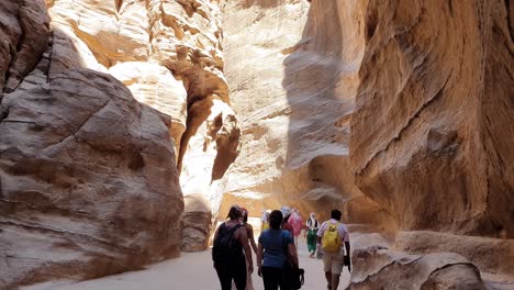 Tourists-walk-in-the-passages-between-the-gorges-on-the-way-to-Petra-in-Jordan