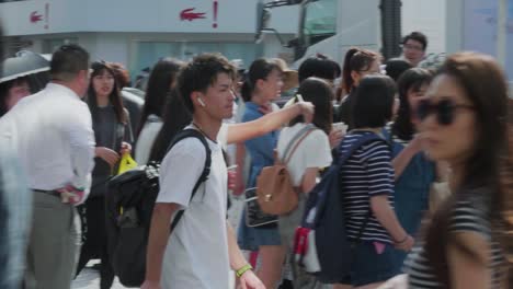 Handheld-tracking-shot-of-pedestrians-walking-in-crowded-Tokyo-street-in-daylight