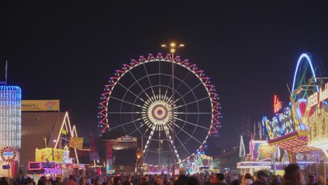 Huge-and-colorful-ferris-wheel-on-a-big-festival-oktoberfest-in-Stuttgart,-Germany-also-called-Wasen-at-night