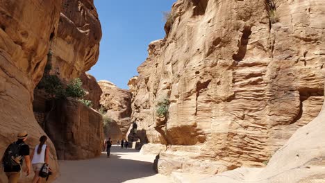 Tourists-walk-along-the-passage-way-toward-the-ancient-city-of-Petra-in-Jordan