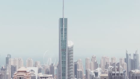 Luftdrohnenaufnahmen-Der-Jumeirah-Lake-Towers-Mit-Dem-Almas-Tower-Vorne-Und-Dem-Dubai-Marina-Im-Hintergrund-An-Einem-Sehr-Sonnigen-Und-Hellen-Tag