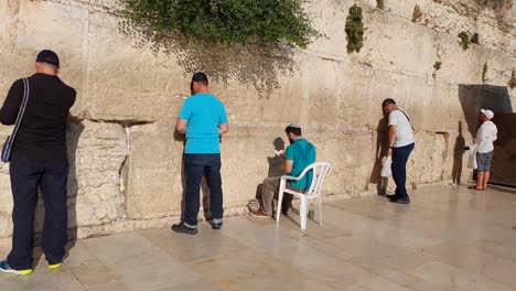 Pan-down-to-see-people-praying-at-the-Western-Wall-in-Jerusalem,-Israel