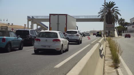 A-Car-is-broken-down-on-the-A7-highway-near-Cala-De-Mijas-and-traffic-is-moving-slowly,-changing-lanes-to-navigate-past