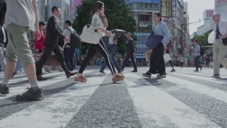 Gente-Caminando-Por-La-Calle-En-El-Famoso-Cruce-Del-Distrito-De-Shibuya-En-Tokio,-Japón
