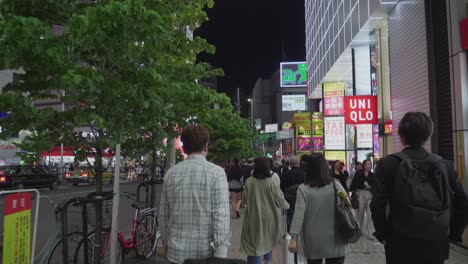 Many-people-walking-through-the-Nightlife-District-Shinjuku-in-Tokyo,-Japan-at-night
