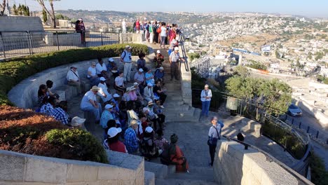 Tourists-listen-to-their-guide-on-the-Mount-of-Olives-overlooking-Jerusalem