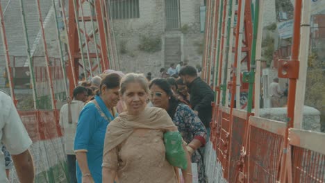 Crowds-Of-People-Crossing-A-Suspension-Bridge-In-India