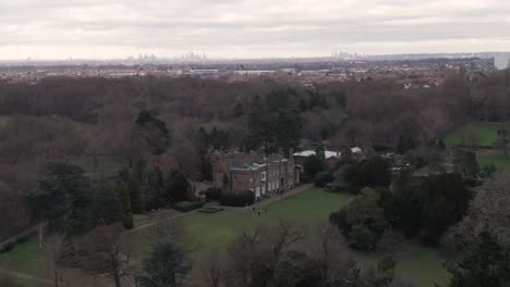 Aerial-view-of-a-traditional-palace-in-South-London-with-the-Downtown-London-Skyline-in-the-far-background