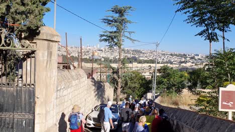 Tourists-walking-down-the-hill-toward-the-Old-city-in-Jerusalem,-Israel