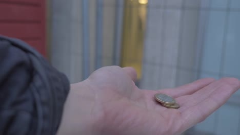 Bettler-Auf-Der-Straße-Lässt-Einige-Münzen-Auf-Seine-Geöffnete-Handfläche-Fallen