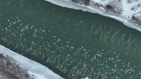 Overhead-drone-shot-of-ice-floating-down-the-Yakima-River-in-rural-Washington