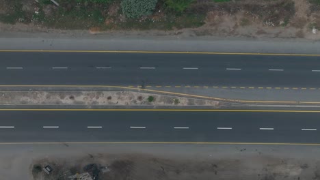 Deserted-highway-strip-in-Punjab,-Pakistan---aerial-top-down-view
