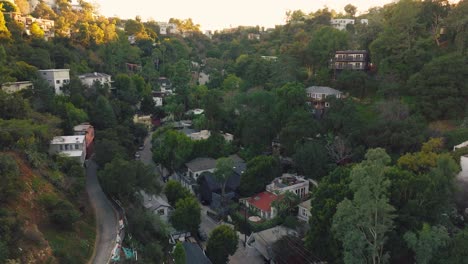 Drone-Footage-of-Laurel-Canyon,-Historical-Neighborhood-in-Los-Angeles-California,-Beautiful-Homes-Tucked-into-Green-Mountains-witih-Shops-and-Roads-Below