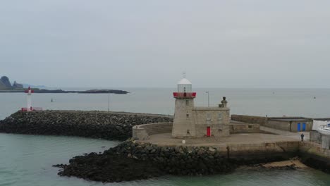 Orbiting-aerial-shot.-Howth-harbour-Lighthouse.-Dublin.-Ireland
