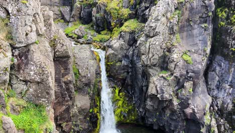 Waterfall-at-the-Akrafjall-mountain-in-Iceland,-high-angle
