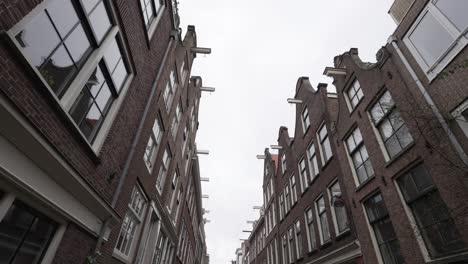 Traditional-dutch-architectural-buildings-in-Amsterdam,-residential-street-in-downtown-area