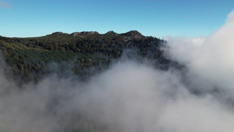 drone-shot-going-forward-revealing-the-pic-des-3-dents-above-the-clouds-in-le-Pilat-Natural-Regional-Park-near-Saint-Etienne-in-Loire-departement,-Auvergne-rhone-alpes-region-in-french-countryside